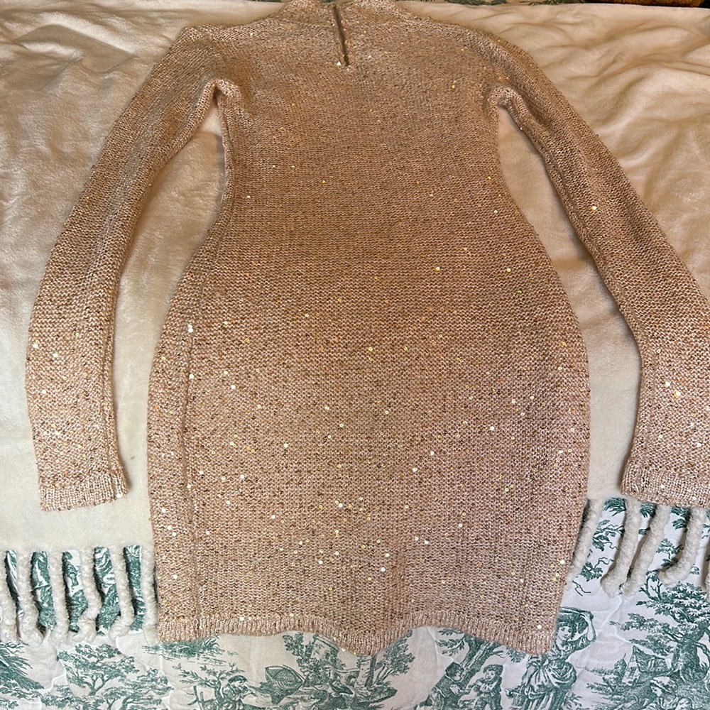 Sequin-accented cream-colored sweater dress.
